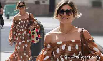 Zoe Hardman oozes glamour in a strapless brown polka dot dress and heart-shaped shades