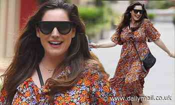 Kelly Brook DANCES in the street on her first day back at work