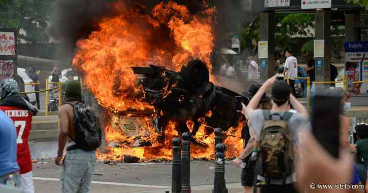 Eight person charged for burning police car at protest