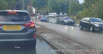 Watch - Parts of town flooded as heavy rain falls