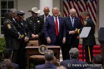 Trump signs executive order on policing, surrounded by law enforcement