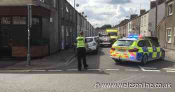 Cardiff street closed after car overturns and lands on its roof