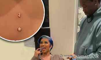 Cardi B holds Offset's hand as she gets three sternum piercings