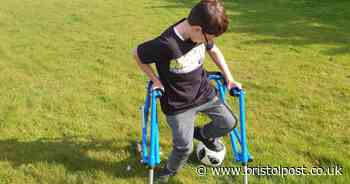 Boy with cerebral palsy dribbles football for first time