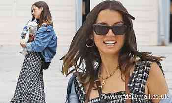 Ana de Armas cradles pooch Elvis as she enjoys beach stroll with female pal