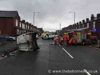 Van flips on its side on Tonge Moor Road after crash with skip wagon