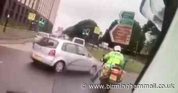 Watch – Driver nearly wipes out cops changing lane on roundabout