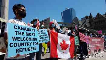 Dozens gather downtown to demand permanent status for refugees amid COVID-19