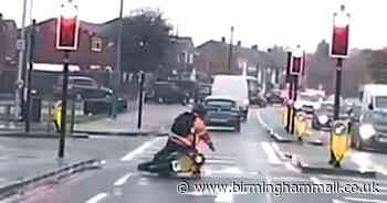Footage captures moment moped rider skids and falls through red light