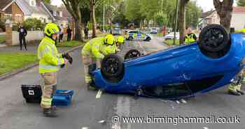 Car overturns after two-vehicle crash on 30mph road