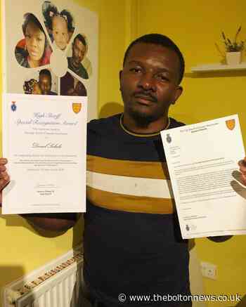 Daniel Sukula, who fled DRC as an asylum seeker receives an award from the High Sheriff