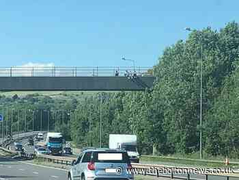 Youths spotted dangling their legs over motorway bridge - police 'strongly advise' parents