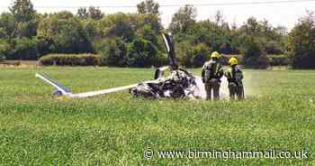 Helicopter crashes into field next to pub as two people miraculously escape