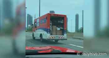 Canada Post truck rear door caught wide open while on Toronto highway | News - Daily Hive
