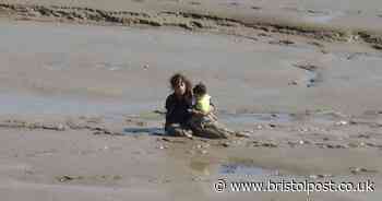Adults carrying children caught in mud flats in Weston-super-Mare