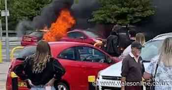 Dramatic video shows fire engulf four cars at retail park