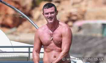 Luke Evans displays his ripped physique on a lavish yacht in Ibiza 