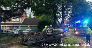 Car flips and smashes onto roof as 'occupants flee'