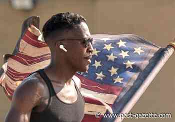 Us: Washington, Pa., Marine runs with an American flag for unity