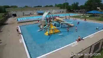 Some community pools and splash pads open today as people try to cool off in the summer heat