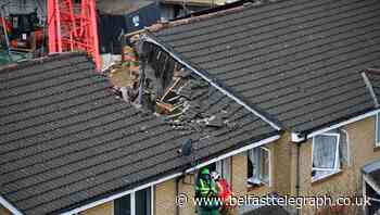 One dead after crane collapses on houses in east London