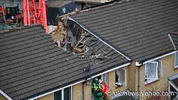 One dead after crane collapses on houses in east London