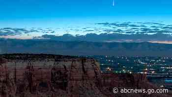 Comet streaking past Earth, providing spectacular show