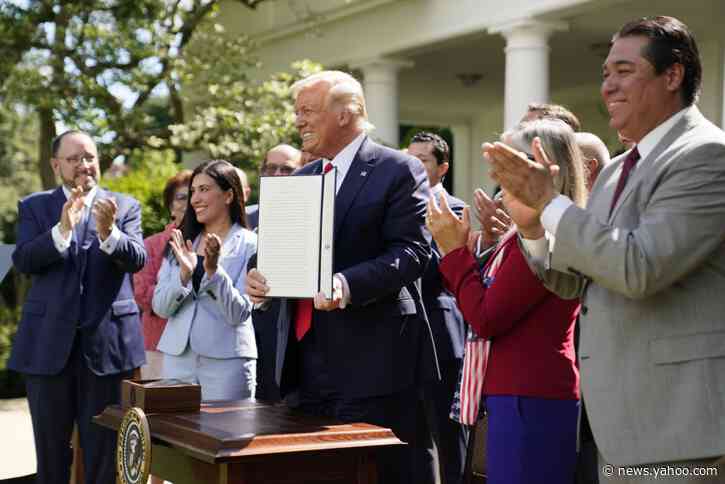 Trump signs executive order as he courts Hispanic voters