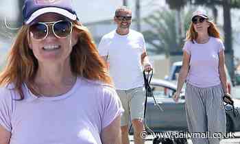 Patsy Palmer flashes a broad smile as she and husband Richard Merkell walk their dogs in Malibu