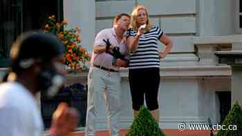 Police search St. Louis mansion of couple who pointed guns at protesters, local reports say