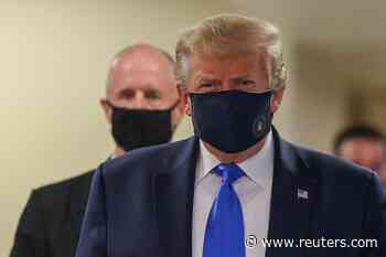 In a first, Trump dons masks in visit to a military medical facility - Reuters