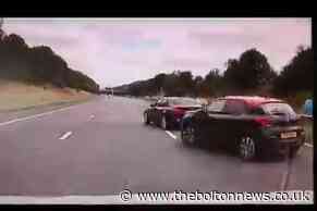 Police car nearly hits driver who ignores motorway road block