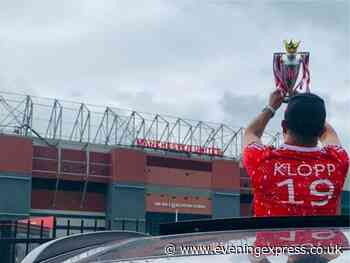 Liverpool fan takes replica Premier League trophy for photo at Old Trafford - Aberdeen Evening Express