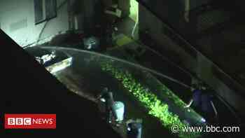 Chinese consulate in Houston: Men filmed using hose in courtyard - BBC News