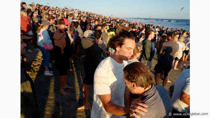 Hundreds gather in Huntington Beach to be baptized with cold dunk in the ocean