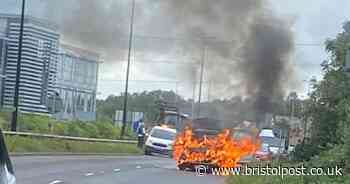 Motorists rush to help stricken driver as car engulfed in flames
