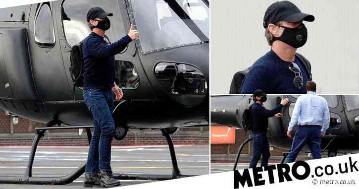 Tom Cruise rocks face mask as he lands in London via helicopter because that’s what action stars do
