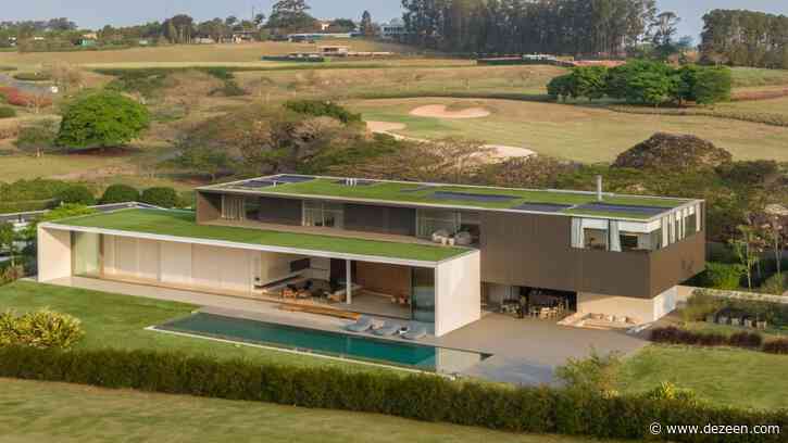 Green roof blends Brazilian house by Studio Arthur Casas with nearby golf course