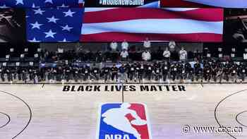 Players, coaches, refs kneel for U.S. anthem as NBA restart tips off