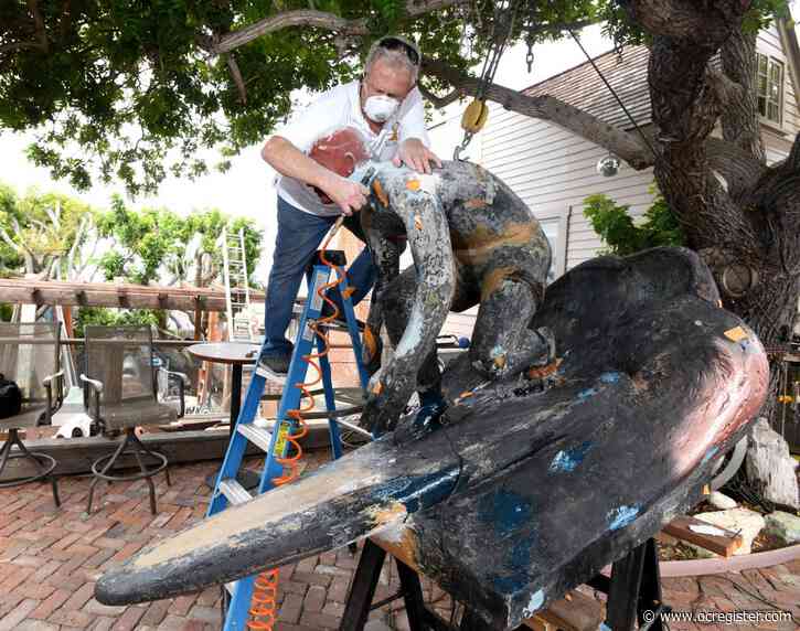 Original statue of a surfing Tim Kelly gets a head during 15-year restoration project