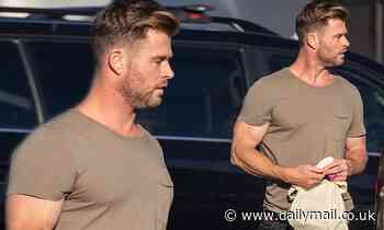 Chris Hemsworth displays his bulging biceps in a tight T-shirt while shopping in Byron Bay - Daily Mail