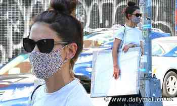 Katie Holmes looks effortlessly chic as she hauls a large portrait back to her NYC apartment