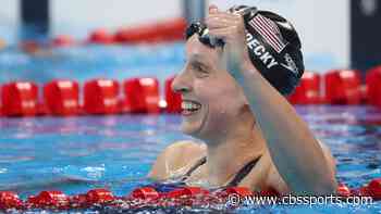 Katie Ledecky swims the length of a pool with a glass of chocolate milk on her head without spilling it