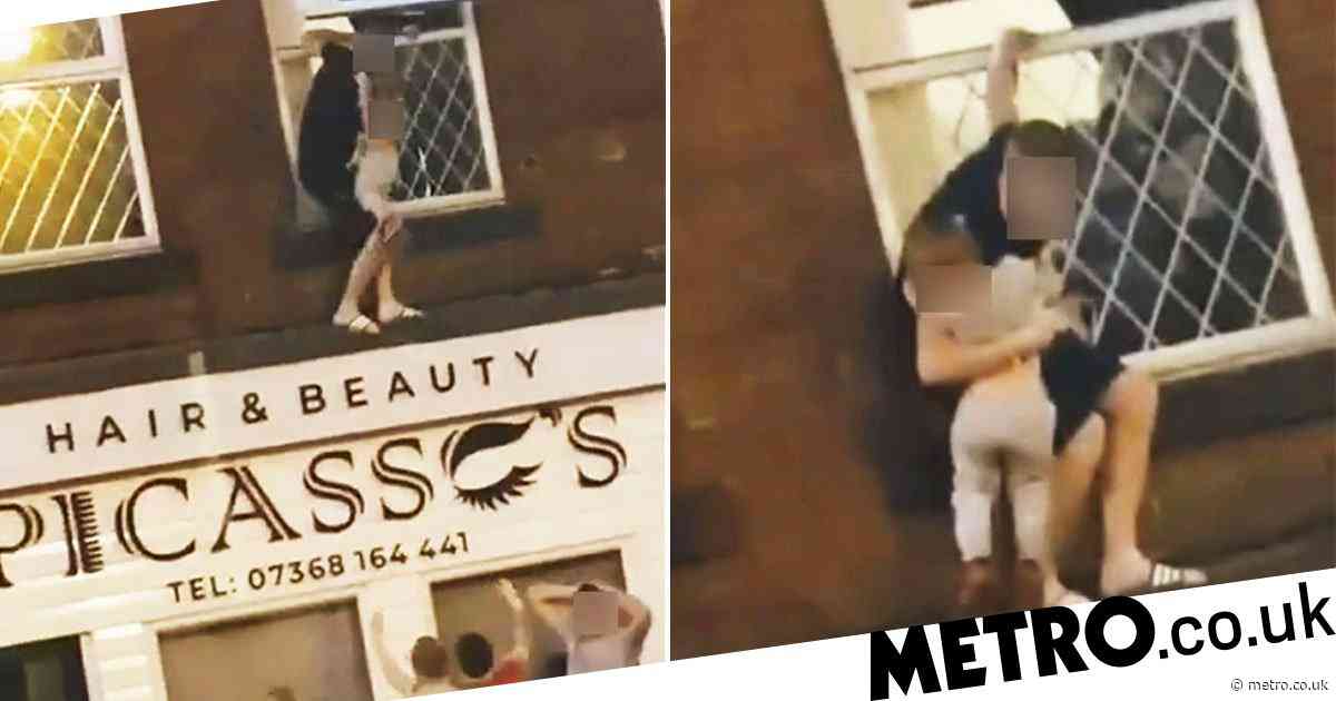 Man climbs out flat window and dangles child over 10ft drop