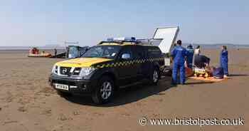 Children on paddle boards rescued on beach after getting stuck in mud