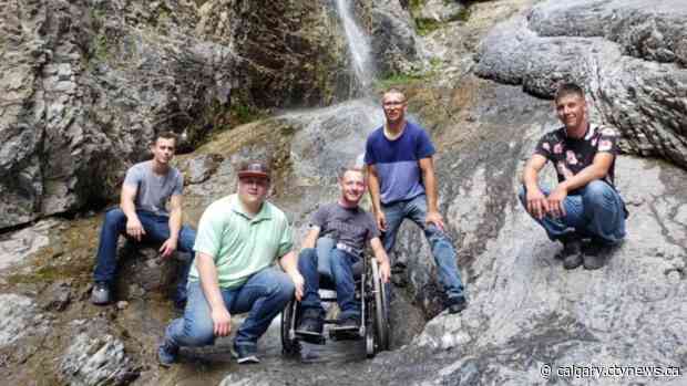 'Aaron goes wherever we go': Friends carry wheelchair-bound man to view waterfall