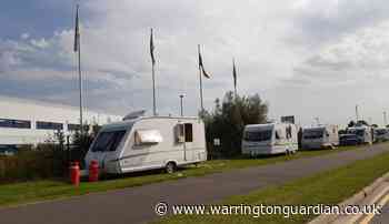 Travellers make camp next to Omega Boulevard warehouses