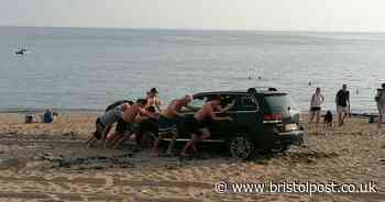 Tempers flare as car gets stuck in the sand at beach