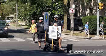 Woman shuts down major Toronto street by driving wheelchair into traffic - blogTO