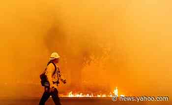 At least 2 people fighting California's raging fires die as thousands flee homes